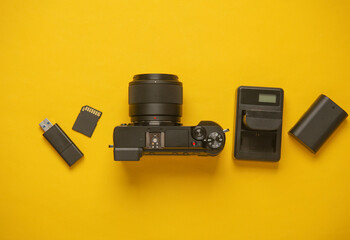 Equipment of modern photographer on a yellow background. Top view. Flat lay