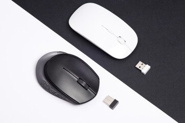 Two Wireless PC mouse with USB flash drives on a black white background. Top view. Creative layout
