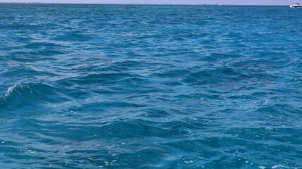 Pristine crystal clear turquoise blue sea water of th Caribbean Atlantic ocean flowing with waves 