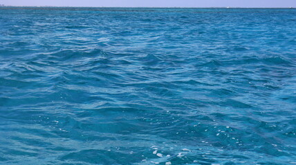 Pristine crystal clear turquoise blue sea water of th Caribbean Atlantic ocean flowing with waves 