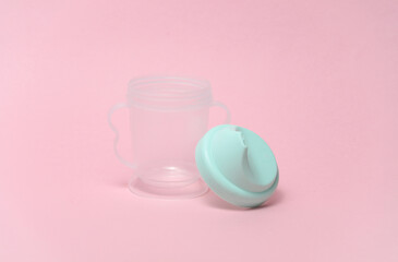 Open Drinking bowl for baby on a pink background.