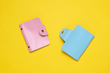 Blue and pink Leather wallets business card holders on yellow background