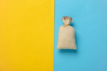 Mini burlap pouch on a blue yellow background