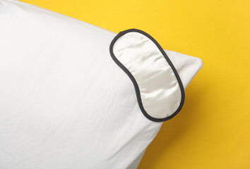 Sleeping mask with pillow on a yellow background. Healthy sleep concept © splitov27