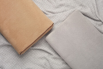 Two orthopedic pillows on a gray blanket