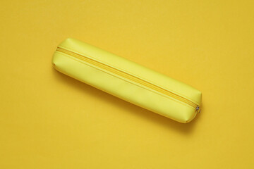 Yellow school pencil case on a yellow background
