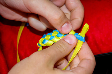 master class with children on making bracelets, weaving of different-colored stitches, hand-made...