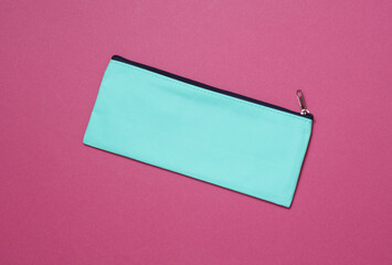 Blue school pencil case on a pink background