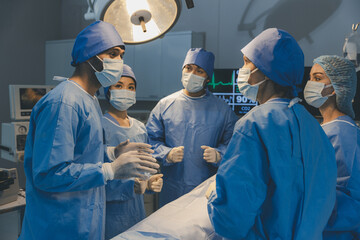 Surgeons team working with Monitoring of patient in surgical operating room. The doctors and nurses...