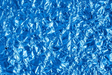 crumpled sheet metal painted blue. background or texture