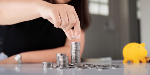 Young Asian woman making stack of coin. invest save finance concept, saving money, investment - obrazy, fototapety, plakaty