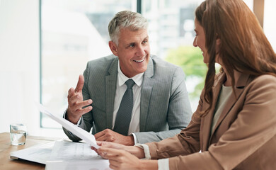 Meeting, businessman and woman with paperwork for advice, planning and conversation at table....