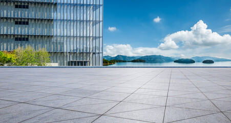 Empty square floor and glass wall with lake background
