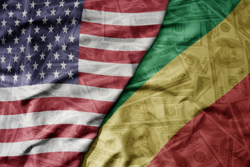 Fototapeta premium big waving colorful flag of united states of america and national flag of republic of the congo on the dollar money background. finance concept .