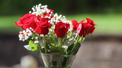 A glass vase of roses for mothers day celebration