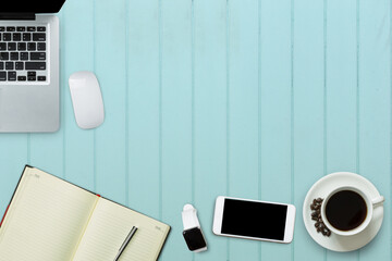Blank screen laptop, smartphone, smart watch, wiress mouse and a cup of coffee on sweet color table