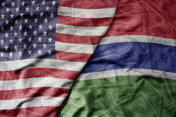 big waving colorful flag of united states of america and national flag of gambia on the dollar money background. finance concept .