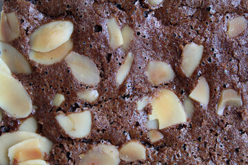 Close up texture of brownies cake upper skin with almond topping