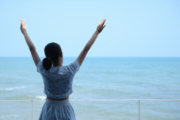 young asia woman stand resting on tropical Beach, travel the sea