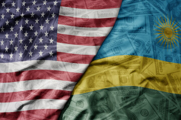 Obraz premium big waving colorful flag of united states of america and national flag of rwanda on the dollar money background. finance concept .
