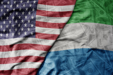 big waving colorful flag of united states of america and national flag of sierra leone on the...