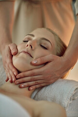 Hands, woman and head on massage table at spa for health, wellness and relax for hospitality at...