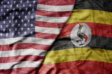 big waving colorful flag of united states of america and national flag of uganda on the dollar...