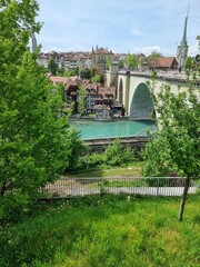 Naklejka premium Bern, Switzerland, view on the Aare river and beautiful antique bridge and typical houses in the background