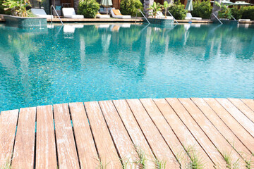 Outdoor swimming pool with wooden deck at resort