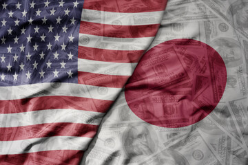 big waving colorful flag of united states of america and national flag of japan on the dollar money...