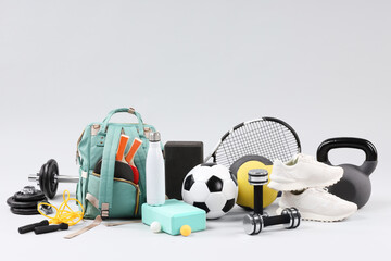 Many different sports equipment on light grey background