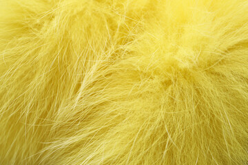 Texture of yellow faux fur as background, closeup