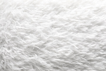 Texture of white faux fur as background, closeup