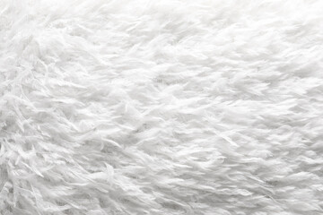Texture of white faux fur as background, closeup