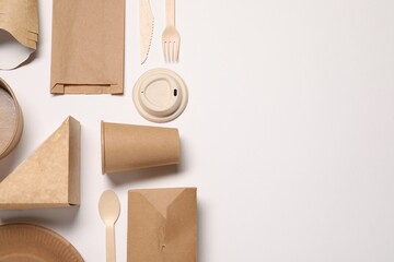 Eco friendly food packaging. Paper containers, bag and tableware on white background, flat lay....