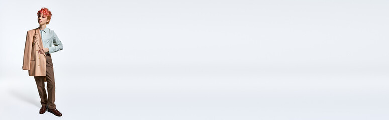 Extraordinary woman in a suit posing against a white background.