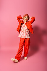 A woman in red pants and a red jacket exudes extravagance and vibrancy.