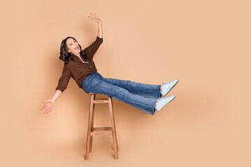 Full size photo of attractive senior woman sit chair playful good mood dressed stylish brown...