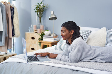 Happy, laptop and woman on bed typing for creative research with journalism project at apartment....