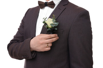 Groom with boutonniere on white background, closeup. Wedding accessory - obrazy, fototapety, plakaty