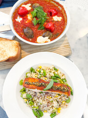 shakshuka with falafel and risotto with salmon, healthy lunch top view