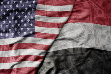 Obraz premium big waving colorful flag of united states of america and national flag of yemen on the dollar money background. finance concept.
