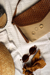 White blouse, straw hat, flat sansdals, tortoiseshell sunglasses, polka dot scrunchie, wicker bag...