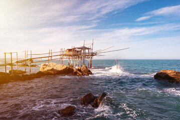 Traditional wooden fishing house with a net near sea coast