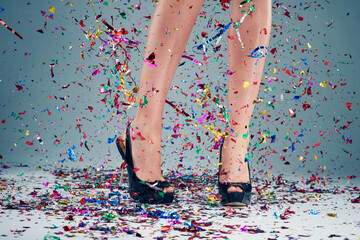 Woman, legs and heels with confetti for party or celebration of new years or decoration for event....