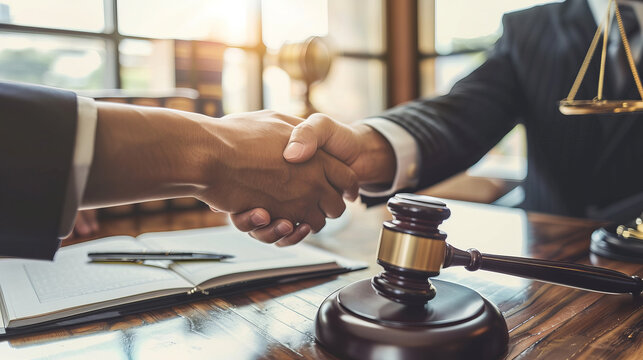 Finishing up meeting. Businessman shaking hands to seal a deal with his partner lawyers or attorneys discussing a contract agreement.
