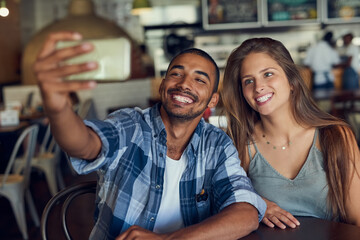 Phone, selfie and happy couple at cafe for brunch date, romance or anniversary celebration....