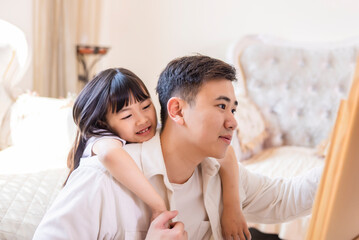 Father and daughter at a drawing game in the living room