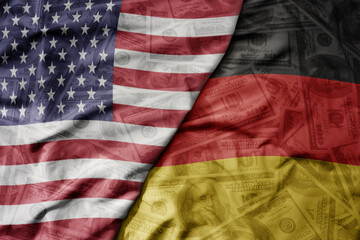 big waving colorful flag of united states of america and national flag of germany on the dollar money background. finance concept.