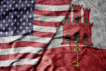 big waving colorful flag of united states of america and national flag of gibraltar on the dollar...
